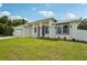 A beautifully landscaped front yard with a modern single-story home and fresh green grass at 4855 Dragon St, North Port, FL 34288