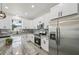 Modern kitchen featuring white cabinets, stainless steel appliances, and granite countertops at 4855 Dragon St, North Port, FL 34288