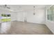 Bright, open-concept living space with wood-look tile flooring and sliding glass doors at 4855 Dragon St, North Port, FL 34288