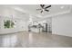 Spacious open-concept area with wood-look tile, white walls, and an island kitchen at 4855 Dragon St, North Port, FL 34288