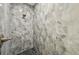 Elegant shower with gray marble tile and black marble flooring at 4855 Dragon St, North Port, FL 34288