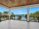 Large outdoor balcony with a beautiful water view and a wood ceiling at 4907 Topsail Dr, Nokomis, FL 34275