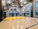 Full indoor basketball court with high ceilings and windows for natural lighting at 4907 Topsail Dr, Nokomis, FL 34275