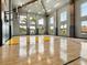 Indoor basketball court with hardwood floors, high ceilings, and large windows at 4907 Topsail Dr, Nokomis, FL 34275