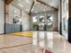 Spacious indoor basketball court with team branding, hardwood floors, and bright lighting at 4907 Topsail Dr, Nokomis, FL 34275