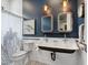 A stylish bathroom featuring vessel sinks, two mirrors and subway tile around the toilet and shower area at 4907 Topsail Dr, Nokomis, FL 34275