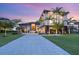 A luxurious modern home with lush landscaping and a long driveway leading to the grand entrance at 4907 Topsail Dr, Nokomis, FL 34275