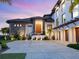 Stunning modern home featuring clean lines, stone accents, manicured landscaping, and a spacious driveway at 4907 Topsail Dr, Nokomis, FL 34275