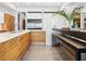 Sleek kitchen with white cabinets, stainless steel appliances, wood accents, and modern design at 4907 Topsail Dr, Nokomis, FL 34275