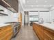 Modern kitchen featuring sleek wood cabinets, stainless steel appliances, and bright lighting at 4907 Topsail Dr, Nokomis, FL 34275
