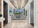 Open-concept living room with large windows and water views plus a decorative stone fireplace at 4907 Topsail Dr, Nokomis, FL 34275