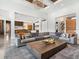 Open concept living room featuring a massive sofa and access to the kitchen and dining areas at 4907 Topsail Dr, Nokomis, FL 34275