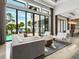 Elegant living room featuring water views, modern furniture, and seamless indoor-outdoor living at 4907 Topsail Dr, Nokomis, FL 34275