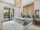 An inviting main bedroom featuring a decorative headboard and balcony with stunning views of the nearby water at 4907 Topsail Dr, Nokomis, FL 34275