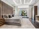 Luxurious main bedroom featuring plush bedding, elegant lighting, and a private sitting area at 4907 Topsail Dr, Nokomis, FL 34275