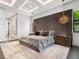 Spacious main bedroom with a plush bed, elegant lighting fixtures, and modern decor at 4907 Topsail Dr, Nokomis, FL 34275
