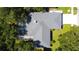 Aerial view showcasing the house layout, pool, and surrounding mature trees at 4913 32Nd E St, Bradenton, FL 34203