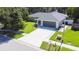 Aerial view of a single-story home featuring a long driveway and lush green landscaping at 4913 32Nd E St, Bradenton, FL 34203