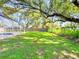 Wonderful spacious backyard with lush lawn bordered by mature trees and beautiful flowers at 4913 32Nd E St, Bradenton, FL 34203