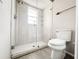 Bathroom featuring a tiled shower with glass door and a modern toilet at 4913 32Nd E St, Bradenton, FL 34203