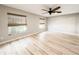 Bright bedroom featuring hardwood floors, two windows with shades, and a ceiling fan at 4913 32Nd E St, Bradenton, FL 34203