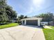 Long driveway leading to a single-story home with an attached garage, surrounded by trees at 4913 32Nd E St, Bradenton, FL 34203