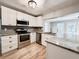 Modern kitchen featuring white cabinets, granite countertops, and stainless steel appliances at 4913 32Nd E St, Bradenton, FL 34203