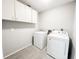 Laundry room with modern washer and dryer, overhead cabinets, and tile floors at 4913 32Nd E St, Bradenton, FL 34203
