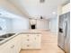 Open floor plan with granite kitchen island overlooking a living room with stone fireplace at 4913 32Nd E St, Bradenton, FL 34203