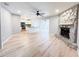 Bright open-concept living area with hardwood floors, stone fireplace, and modern kitchen view at 4913 32Nd E St, Bradenton, FL 34203