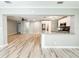Open concept living room with wood-look floors and a breakfast bar to the kitchen at 4913 32Nd E St, Bradenton, FL 34203