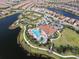 Breathtaking aerial shot of the community pool, lake, and surrounding homes at 5234 Napoli Run, Bradenton, FL 34211