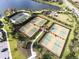 Aerial view of well-maintained tennis courts, bocce ball courts, playground and lush landscaping, showcasing a vibrant community at 5234 Napoli Run, Bradenton, FL 34211
