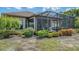 The home's backyard with a screened lanai and landscaped garden beds offers privacy and relaxation at 5234 Napoli Run, Bradenton, FL 34211