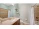 Bright bathroom showcasing a granite-topped vanity with a single sink, complemented by tiled walls and a shower with a curtain at 5234 Napoli Run, Bradenton, FL 34211