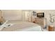 Cozy bedroom featuring a calm atmosphere, neutral color scheme, TV, and a decorative wall shelf at 5234 Napoli Run, Bradenton, FL 34211