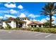 Beautiful exterior of a clubhouse with tile roofing, manicured landscaping, and ample parking space at 5234 Napoli Run, Bradenton, FL 34211