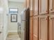 Functional laundry room featuring ample cabinetry, modern washer and dryer, and a window providing natural light and ventilation at 5234 Napoli Run, Bradenton, FL 34211