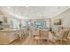 Open-concept living area featuring a kitchen island, breakfast bar, views into the living and dining area at 5234 Napoli Run, Bradenton, FL 34211