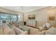 Spacious living room with comfortable seating and sliding glass doors to the outdoor space at 5234 Napoli Run, Bradenton, FL 34211