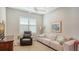 Inviting living room with plush sofa, comfortable armchair, and a large window offering natural light, perfect for relaxation at 5234 Napoli Run, Bradenton, FL 34211