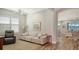 Comfortable living room featuring a plush sofa and a recliner, with an open view to the dining area, creating a connected space at 5234 Napoli Run, Bradenton, FL 34211