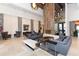 Lobby featuring modern decor, comfortable seating, stone pillars, fireplace and stylish lighting fixtures at 5234 Napoli Run, Bradenton, FL 34211
