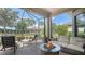 Relaxing screened-in patio with comfortable seating around a fire pit, overlooking a beautifully landscaped yard and garden at 5234 Napoli Run, Bradenton, FL 34211