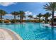 Resort-style pool featuring tropical landscaping, clear blue water, lounge chairs and orange-colored cabanas for relaxing in the sun at 5234 Napoli Run, Bradenton, FL 34211