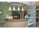 Inviting reception area with pendant lights, drink station, and textured accent wall at 5234 Napoli Run, Bradenton, FL 34211