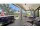 This screened-in patio offers a relaxing space with comfortable seating, a hot tub, and views of the lush landscaping at 5234 Napoli Run, Bradenton, FL 34211