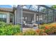 This screened patio features a hot tub, lounge chairs, and an outdoor dining area, all surrounded by colorful landscaping at 5234 Napoli Run, Bradenton, FL 34211