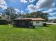 Back of house features a screened in lanai and a beautiful green lawn at 5629 Boulder Blvd, Sarasota, FL 34233