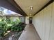 Covered entryway featuring a front door and landscaping; ramp for accessibility at 5629 Boulder Blvd, Sarasota, FL 34233